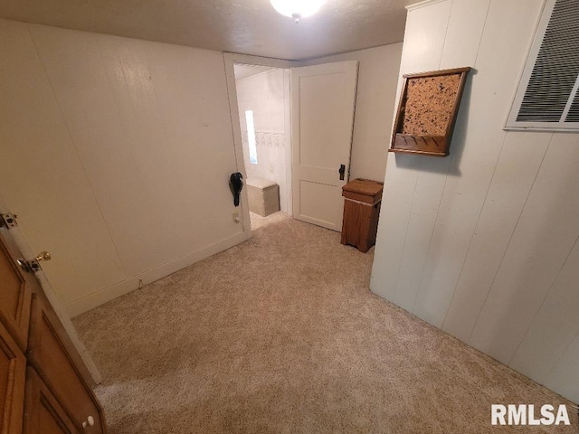 empty room with light colored carpet