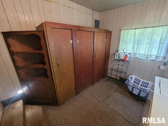 bedroom featuring wooden walls