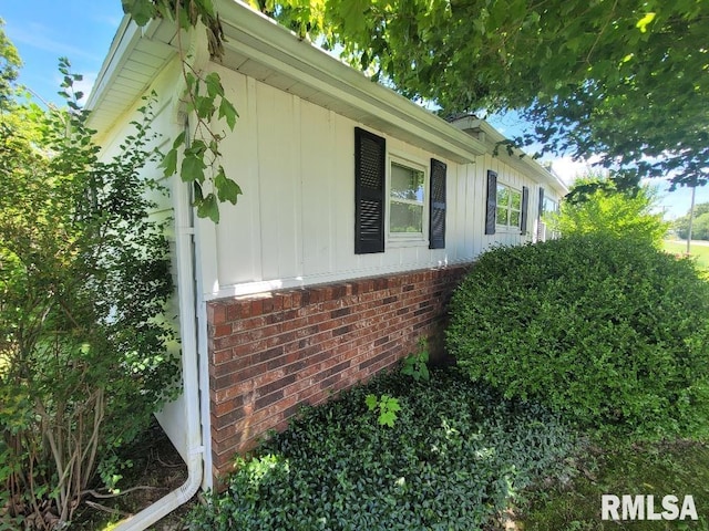 view of side of home with brick siding and board and batten siding