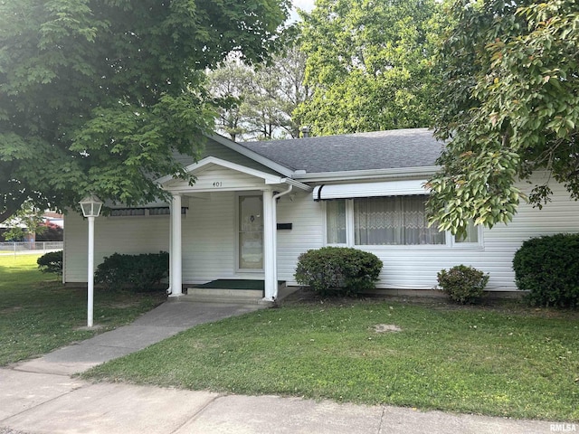 401 W 11th St, Christopher, IL 62822 - view of front of home with a front lawn and a shingled roof