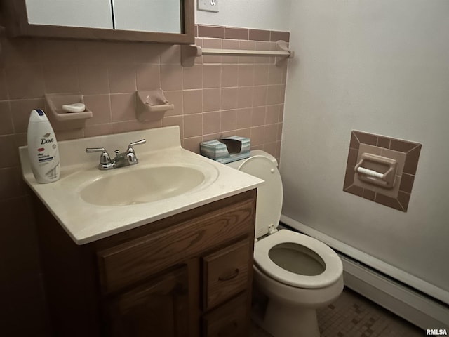 401 W 11th St, Christopher, IL 62822 - half bath featuring toilet, vanity, tile walls, and baseboard heating