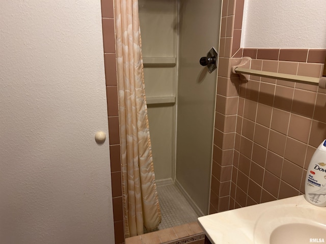 401 W 11th St, Christopher, IL 62822 - full bath with a textured wall, a stall shower, and tile walls