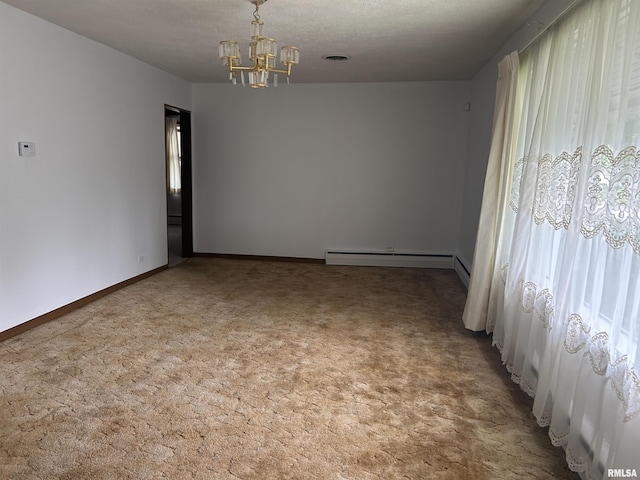 401 W 11th St, Christopher, IL 62822 - empty room with baseboard heating, a chandelier, carpet flooring, and baseboards