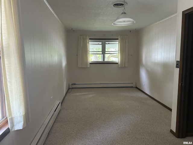 401 W 11th St, Christopher, IL 62822 - carpeted spare room with a baseboard radiator, baseboards, wooden walls, and crown molding