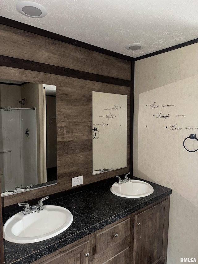 bathroom with double vanity and a shower