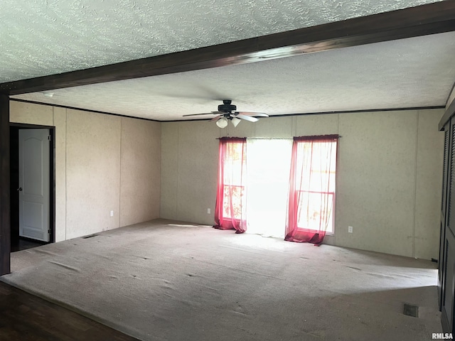 unfurnished room with ceiling fan, a textured ceiling, carpet floors, and beam ceiling