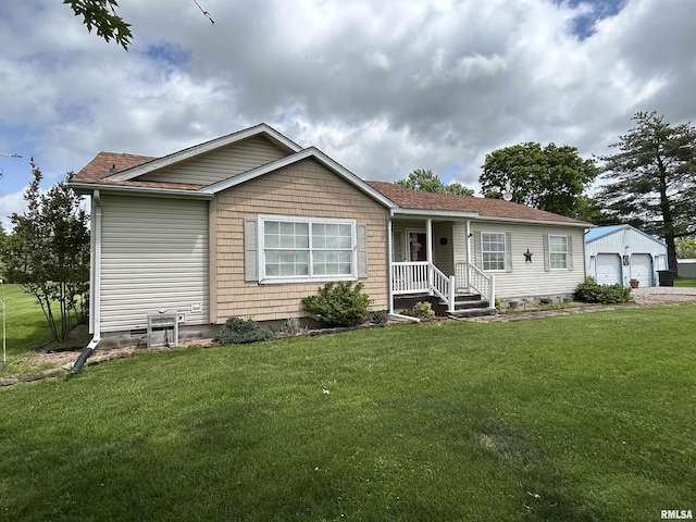 single story home featuring a detached garage, a front yard, an outbuilding, and a shingled roof