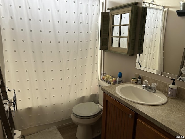 bathroom with toilet, vanity, wood finished floors, and a shower with curtain
