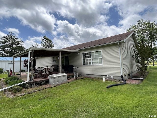 rear view of property featuring a lawn and a patio