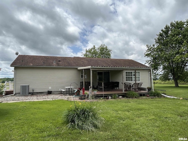 rear view of house with a lawn and a deck