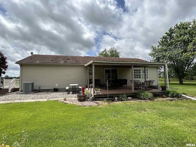 back of property featuring central AC unit, a yard, and a wooden deck