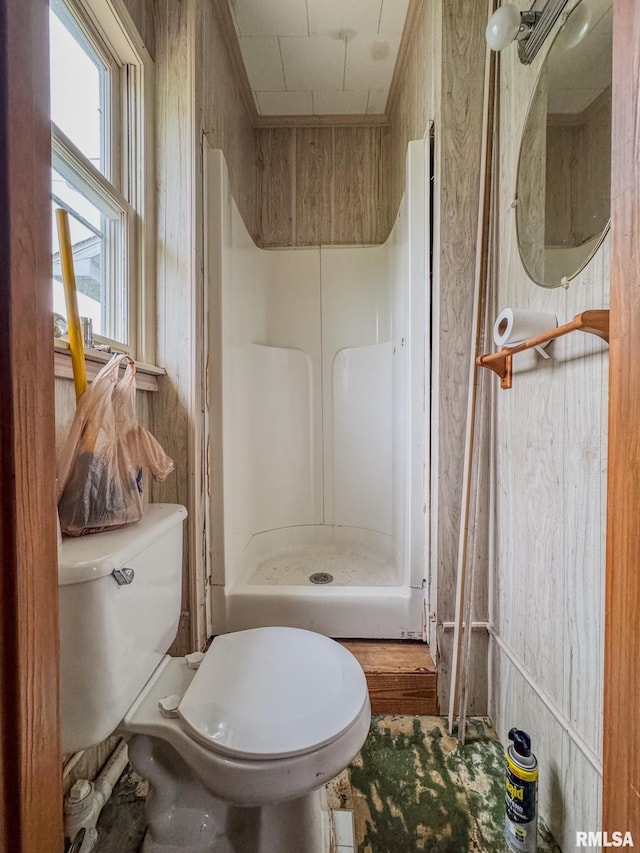 bathroom with toilet and a stall shower