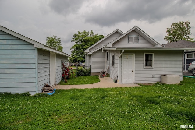 back of property with a lawn