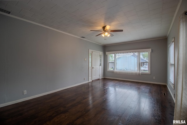 spare room with crown molding, a ceiling fan, dark wood-type flooring, and baseboards