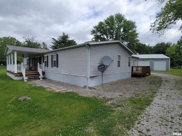 3614 S Hotze Rd, Salem, IL 62881 - view of side of property featuring a porch, a lawn, and a detached garage