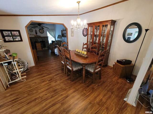 3614 S Hotze Rd, Salem, IL 62881 - dining room with wood finished floors, crown molding, ceiling fan, a chandelier, and a fireplace