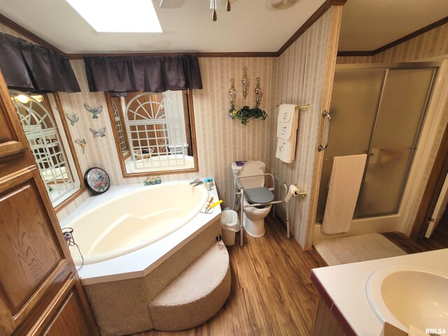 3614 S Hotze Rd, Salem, IL 62881 - bathroom with wallpapered walls, a shower stall, a garden tub, wood finished floors, and vanity