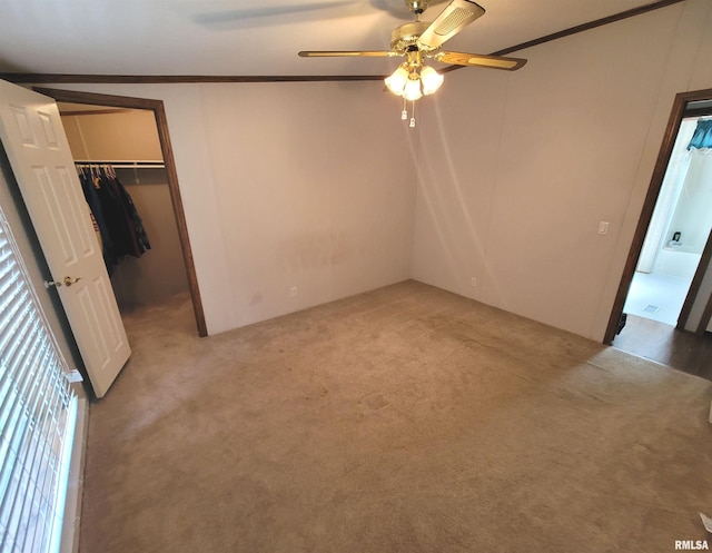 3614 S Hotze Rd, Salem, IL 62881 - unfurnished bedroom with ornamental molding, a spacious closet, light carpet, a closet, and a ceiling fan
