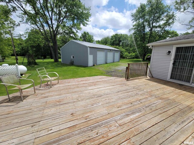 3614 S Hotze Rd, Salem, IL 62881 - deck with a garage, an outbuilding, a lawn, and view of wooded area
