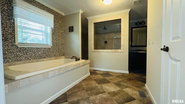 full bathroom with ornamental molding, a bath, walk in shower, vanity, and baseboards