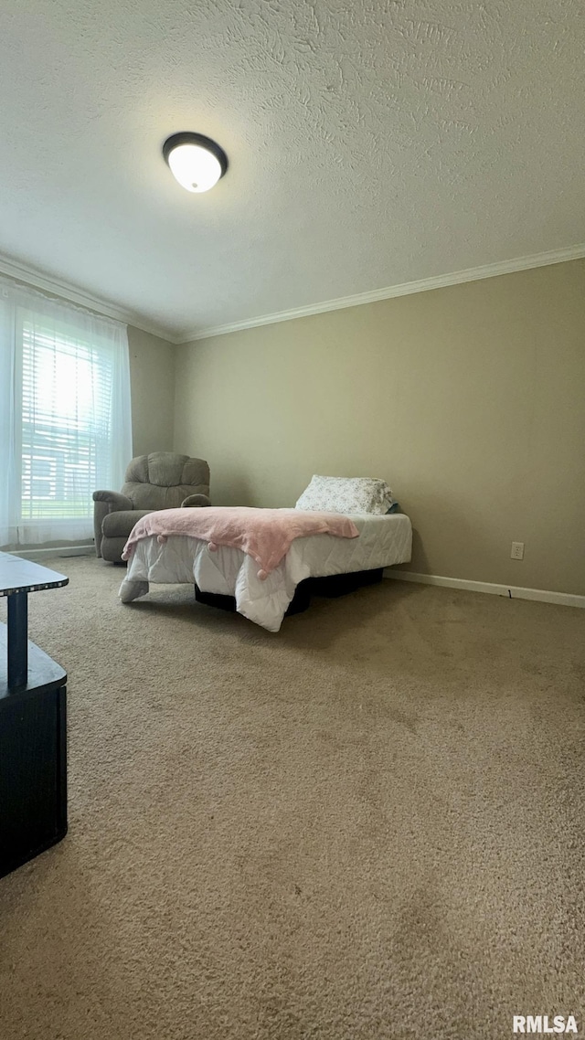 carpeted bedroom featuring ornamental molding, baseboards, and a textured ceiling