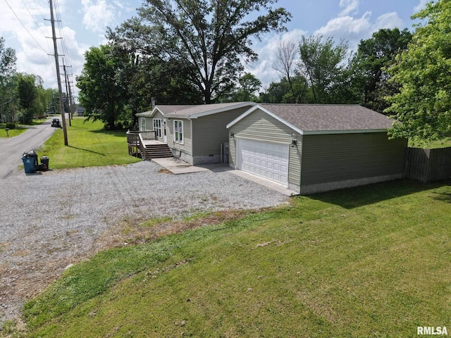 view of front of house with driveway, a front yard, an attached garage, and a deck