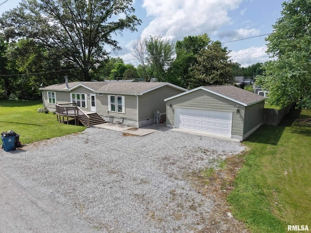 view of front of home featuring a detached garage, an outbuilding, roof with shingles, and a front lawn