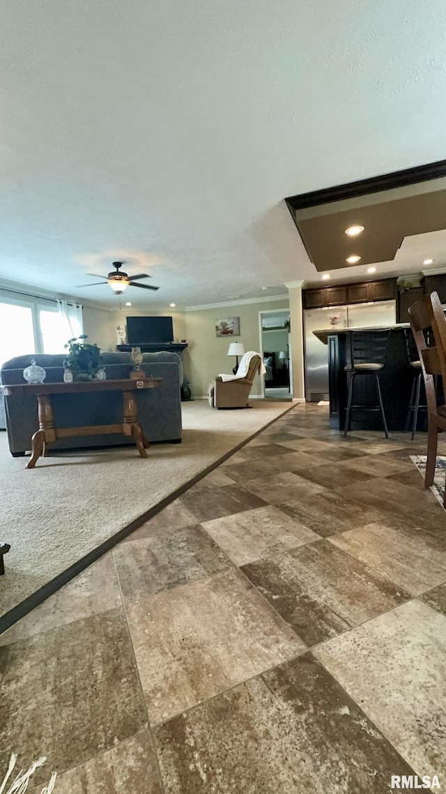 living area featuring ceiling fan and recessed lighting