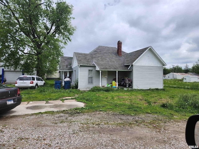 177 E White St, Ashley, IL 62801 - view of front of property featuring a chimney and roof with shingles