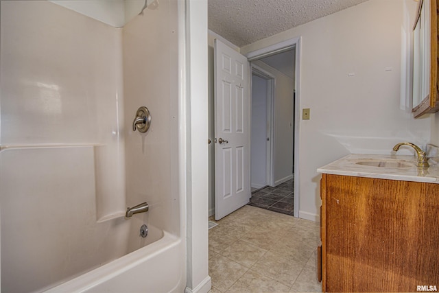 1103 W Boone St, Salem, IL 62881 - full bathroom with a textured ceiling,  shower combination, tile patterned floors, baseboards, and vanity