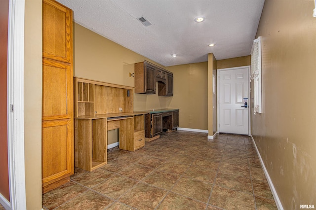 1103 W Boone St, Salem, IL 62881 - kitchen featuring baseboards, a textured ceiling, brown cabinets, dark stone finish floors, and recessed lighting