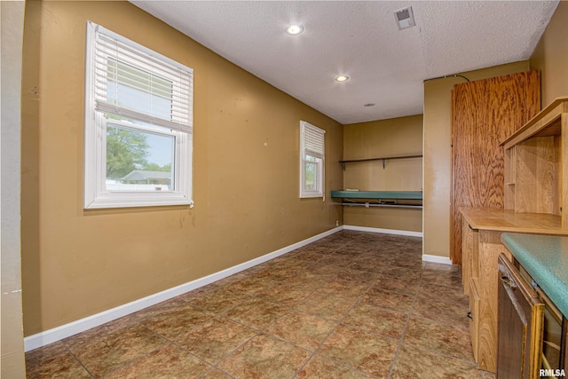 1103 W Boone St, Salem, IL 62881 - unfurnished dining area with a textured ceiling, baseboards, recessed lighting, and stone finish floors
