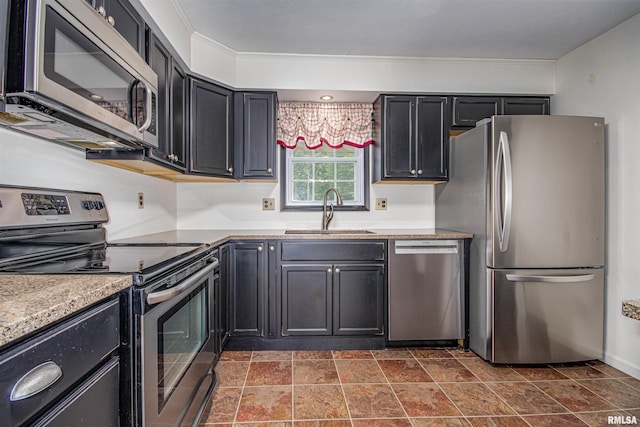 1103 W Boone St, Salem, IL 62881 - kitchen with appliances with stainless steel finishes, a sink, dark cabinets, and dark stone finish flooring