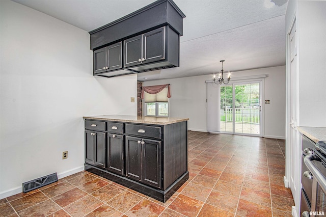 1103 W Boone St, Salem, IL 62881 - kitchen featuring a chandelier, range, baseboards, and light countertops