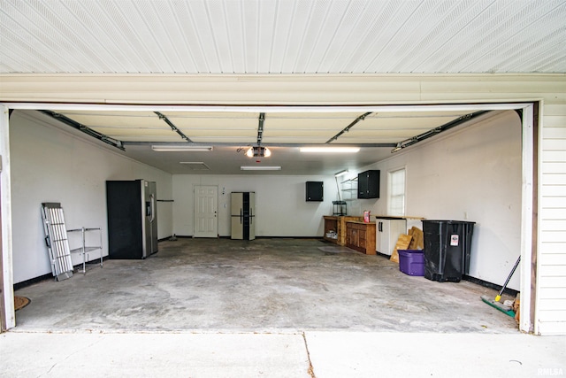 1103 W Boone St, Salem, IL 62881 - garage featuring freestanding refrigerator, a garage door opener, electric panel, and stainless steel refrigerator with ice dispenser