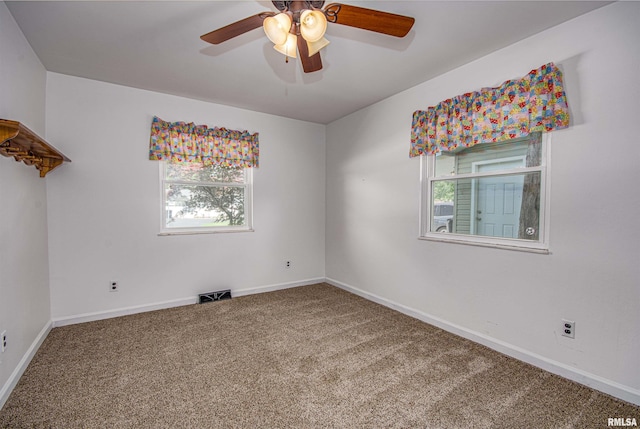 1103 W Boone St, Salem, IL 62881 - empty room featuring carpet floors, plenty of natural light, and a ceiling fan