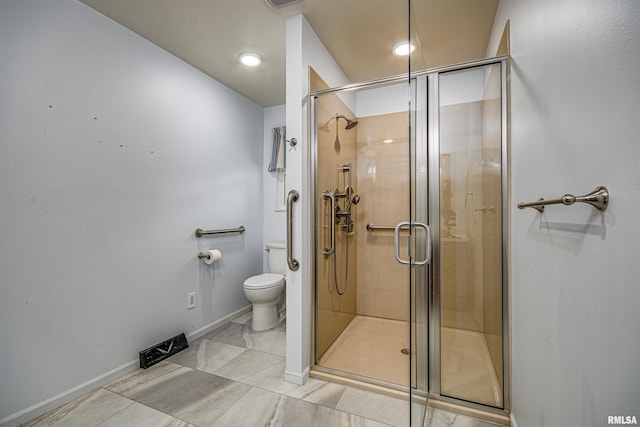 1103 W Boone St, Salem, IL 62881 - bathroom featuring toilet, a stall shower, tile patterned flooring, and baseboards
