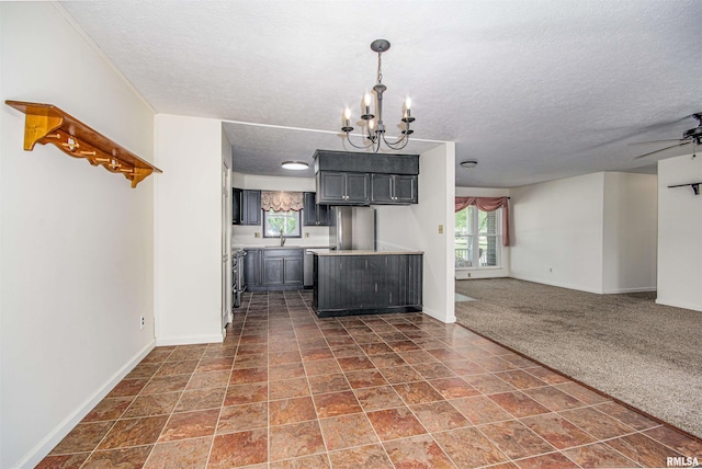 1103 W Boone St, Salem, IL 62881 - kitchen featuring a textured ceiling, open floor plan, a sink, a chandelier, and baseboards