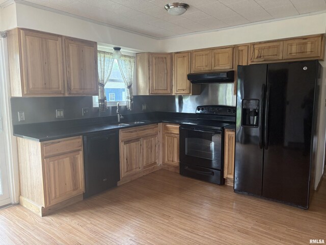100 N 35th St, Herrin, IL 62948 - kitchen with black appliances, a sink, under cabinet range hood, dark countertops, and light wood-style floors