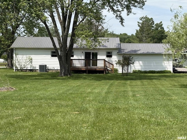 100 N 35th St, Herrin, IL 62948 - rear view of house with central AC, a wooden deck, a yard, and metal roof