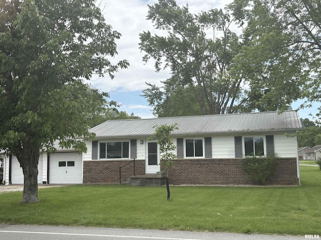 100 N 35th St, Herrin, IL 62948 - ranch-style house with brick siding, a garage, a front lawn, and metal roof