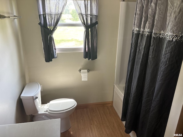 100 N 35th St, Herrin, IL 62948 - full bath featuring baseboards, toilet, shower / tub combo with curtain, and wood finished floors