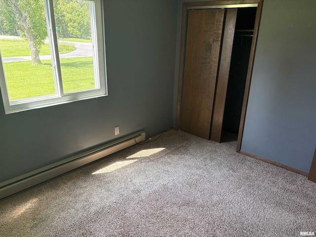 100 N 35th St, Herrin, IL 62948 - unfurnished bedroom with carpet, a baseboard radiator, and a closet