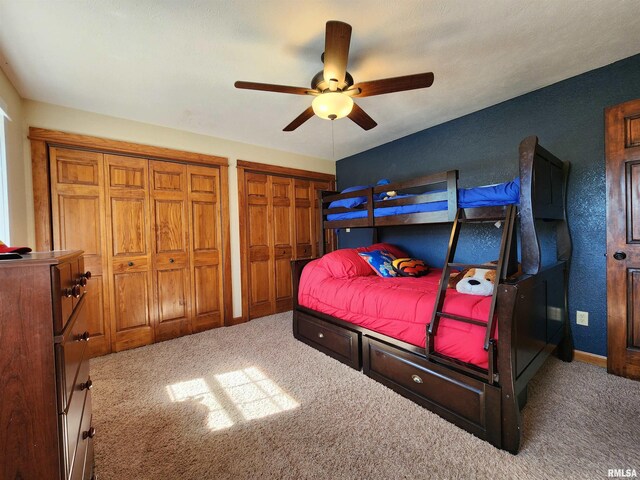 580 Blackman Hill Rd, Harrisburg, IL 62946 - carpeted bedroom with multiple closets, a ceiling fan, and baseboards