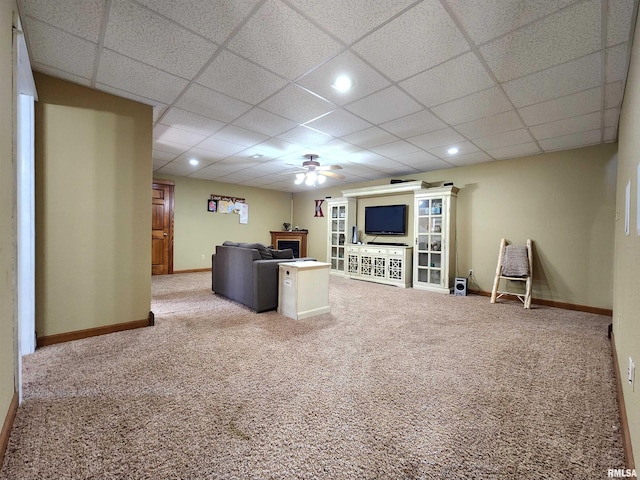 580 Blackman Hill Rd, Harrisburg, IL 62946 - living room featuring carpet flooring, a paneled ceiling, a ceiling fan, baseboards, and a fireplace