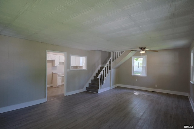 621 E Oglesby, Salem, IL 62881 - unfurnished living room with stairs, dark wood-type flooring, baseboards, and a ceiling fan