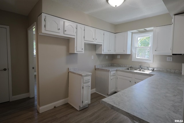 621 E Oglesby, Salem, IL 62881 - kitchen with a sink, dark wood-style flooring, white cabinetry, baseboards, and a textured ceiling