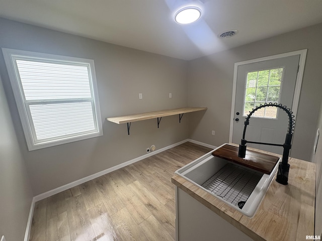116 Lindsey Ave, Metropolis, IL 62960 - kitchen featuring baseboards, light wood-style floors, and light countertops