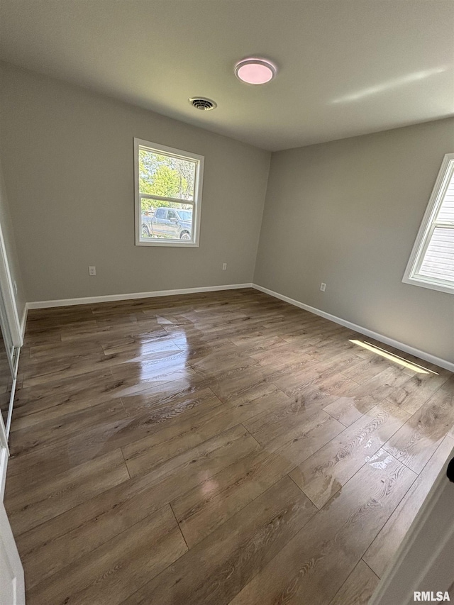 116 Lindsey Ave, Metropolis, IL 62960 - empty room with dark wood-type flooring, plenty of natural light, and baseboards