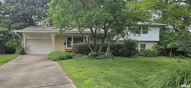 1608 W Briarwood Dr, Carbondale, IL 62901 - split level home with brick siding, a front yard, a garage, and driveway
